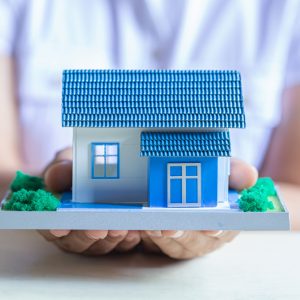 human-hands-holding-model-dream-house